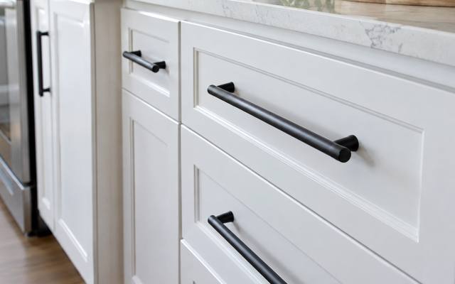 White painted drawers fitted with long black bar pulls.